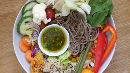 Top View of Rotating Plate with Wholegrain Noodles Quinoa and Various Vegetables