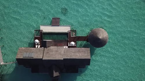Huge water villa at the Maldives resort in the middle of the ocean. view from above. 4K