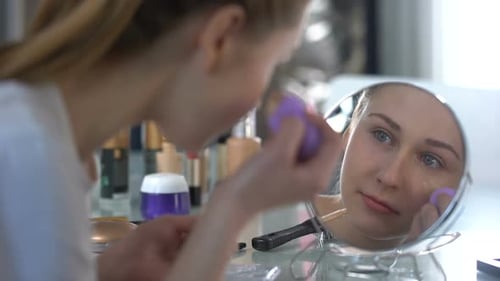 Woman Applies Makeup with Beauty Blender at Home