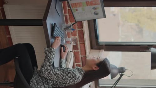 Woman Working at Desk in Urban Office