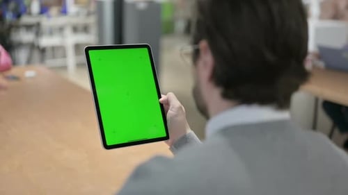Man Using Tablet with Green Chroma Screen