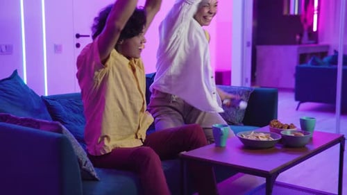 Young Couple Playing Video Games at Home at Night