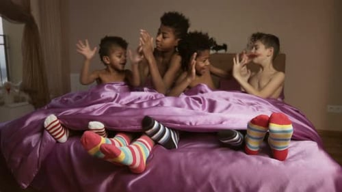 Children Clapping and Laughing in Bed