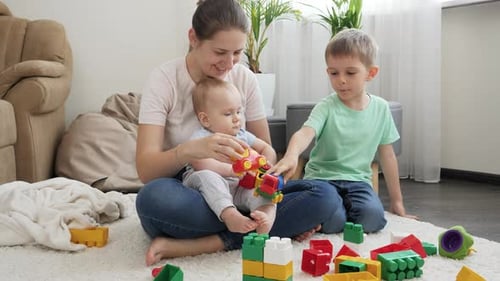 Mother and Children Playing with Toys at Home