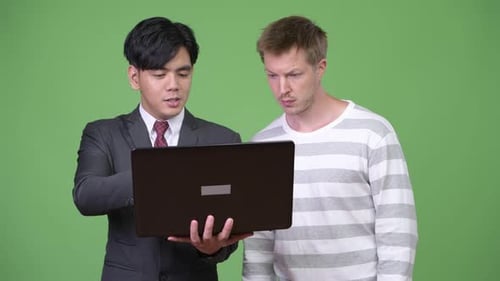 Two Young Adults Looking at Laptop