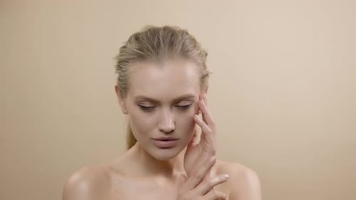 Close Up of Woman Touching Her Face