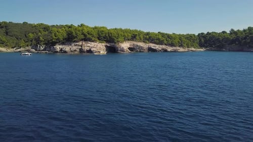 Rocky Coastline With Caves And Boats. View From Fast Boat