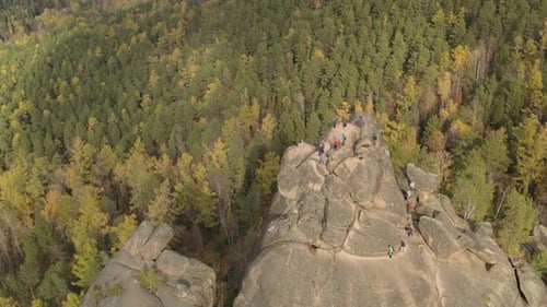 A Group of Tourists Climbing To the Top of the Mountain.