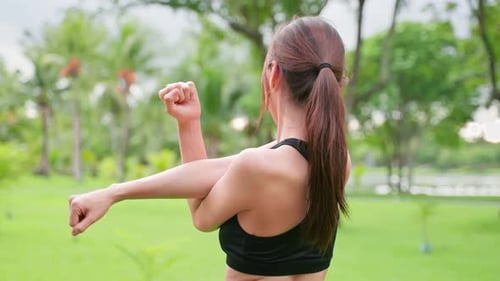 Portrait of Asian young beautiful sport woman stretching body in park.