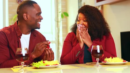 Man Proposing to Woman in Romantic Dinner Setting