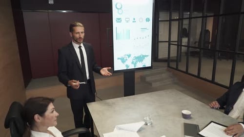 Business Meeting in Office, Young Businessman Speak at a Meeting and Shows Financial Infographic in