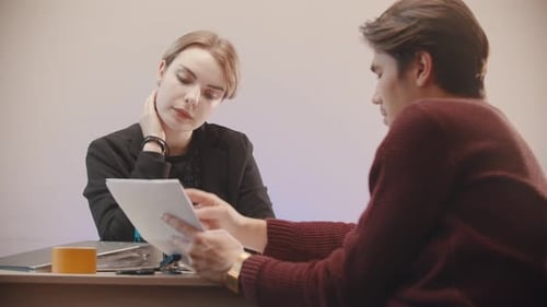 Man Telling What Is on the Documents and the Girl Is Listening