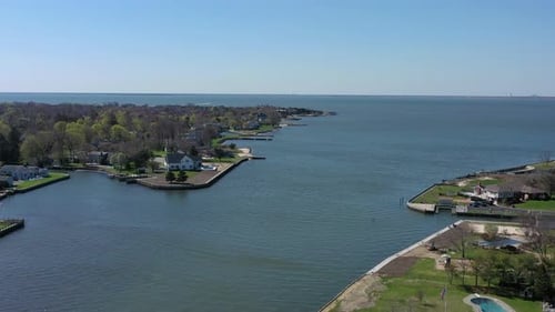 A high angle view over Bay Shore, NY, on a sunny day with clear skies. The camera dolly in over the