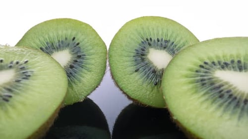 Close-up of Fresh, Green Kiwi Slices on Black