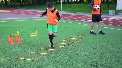 Boys Practice Soccer Drills on Field