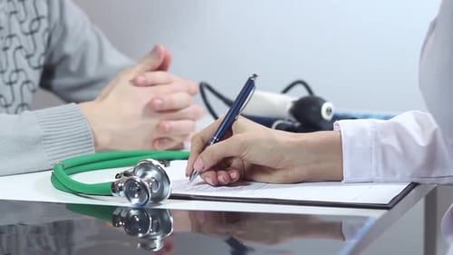 Doctor Consultation and Writing in Clinic Office