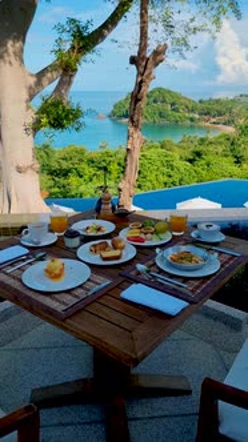 Breakfast on the Beach in Thailand a Luxury Breakfast Table with Food and Beautiful Tropical Sea