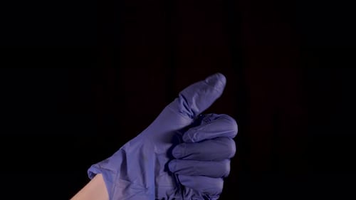 Hand in Blue Glove Gives Thumbs Up