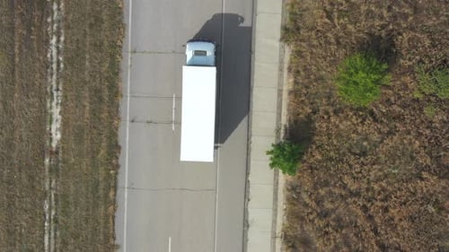 Aerial View of Truck with Trailer Driving on Straight Road and Transporting Goods