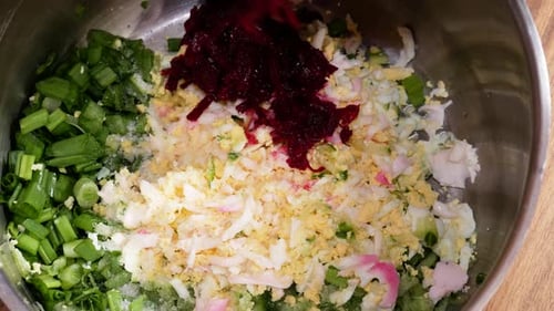 Adding beetroots next to other ingredients to make cold beetroot soup