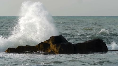 Rough Sea Crushing the Rocks with High Splashes