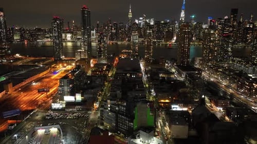 An aerial timelapse by the entrance of the Midtown Tunnel in Long Island City, New York at night. Th