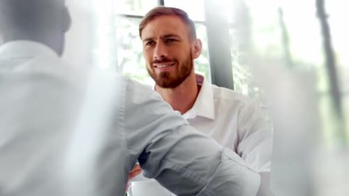 Businesspeople interacting with each other while having breakfast