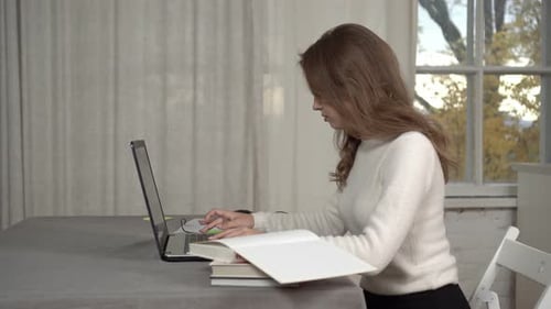Young Woman Working on Laptop at Home