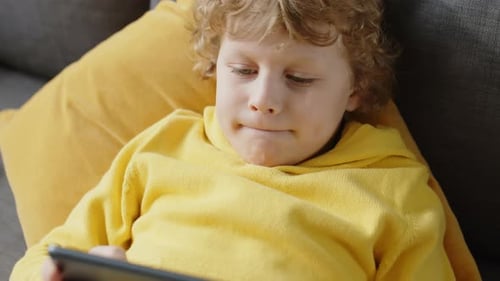 Little Boy Enjoying Game on Digital Tablet