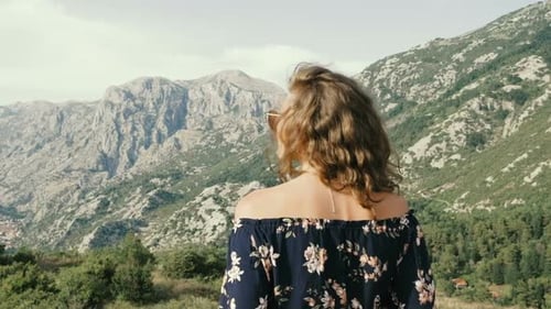Woman Enjoys Mountain View in Floral Top