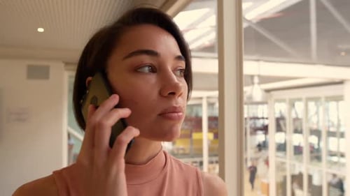 Businesswoman talking on mobile phone in a modern office 4k