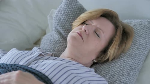 Relaxing Old Senior Woman Sleeping in Bed