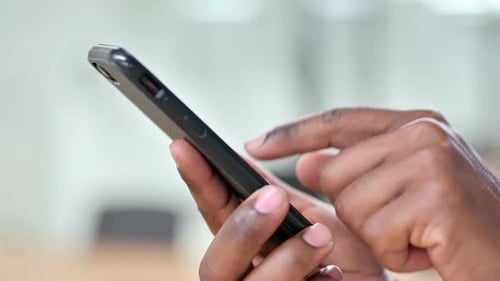 Close Up of African Man Using Smartphone