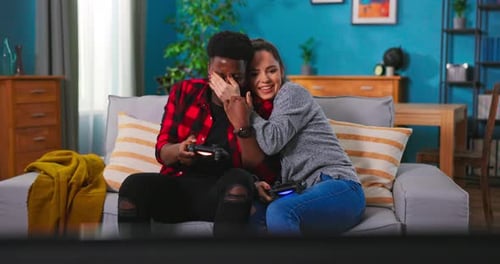 Happy Couple Playing Video Games Together at Home