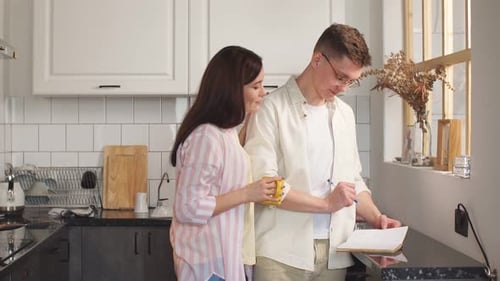 Young Couple Planning Together in Bright Kitchen