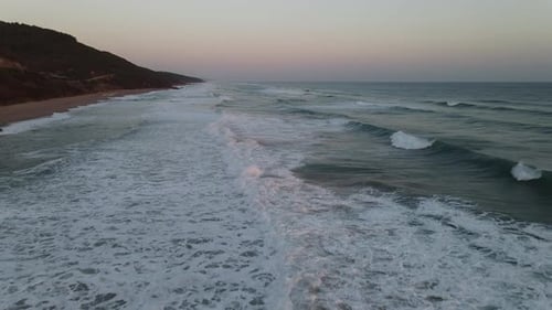 Coastal Waves on a Tranquil Beach at Dusk