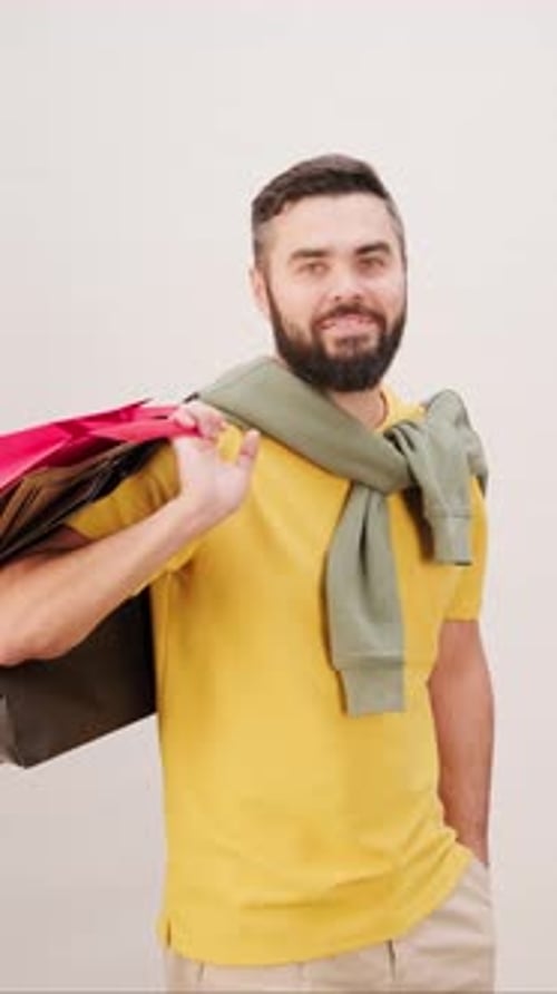 Smiling Man with Shopping Bags in Studio