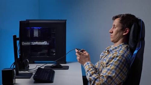 Young Adult Playing Video Games at Home