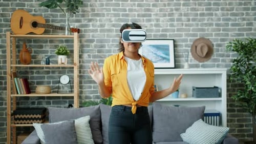 Young Woman Enjoys Virtual Reality at Home