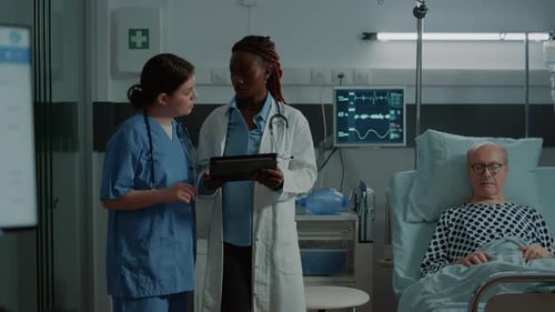 Doctors Checking on Patient in Hospital Room
