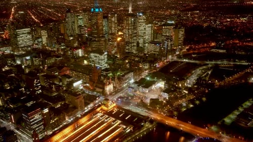 Night timelapse of busy downtown Melbourne city filled with movements of pedestrians, traffics and