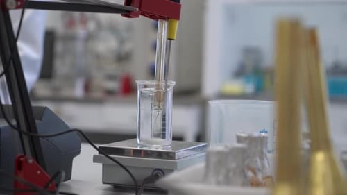 Liquid Being Added to Beaker in Scientific Experiment