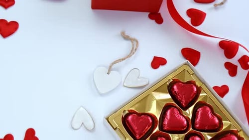 Gifts and Heart-Shaped Chocolates on White Surface