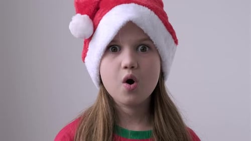 Close Up Surprised Christmas Girl in Santa Hat on White Background