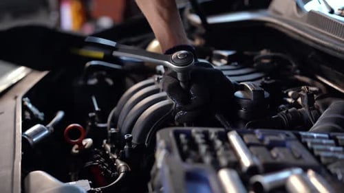 Mechanic Repairing Car Engine at Workshop