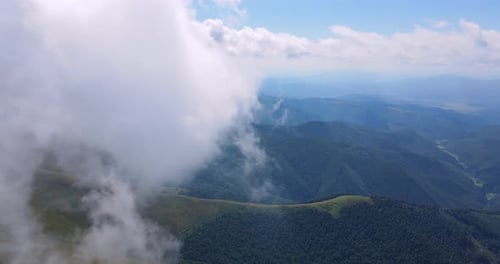 Aerial View of Mountain Range with Forest and Clouds