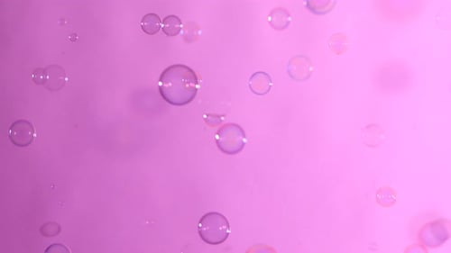 Blue and Clear Soap Bubbles on Light Pink, Background