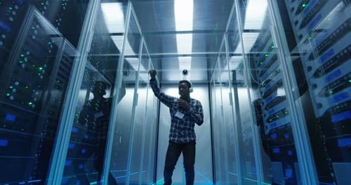Young Man Dancing Enthusiastically in a Server Room