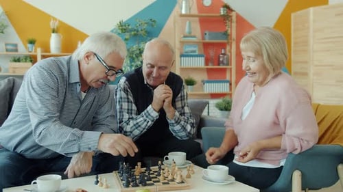 Mature Friends Play Chess Together