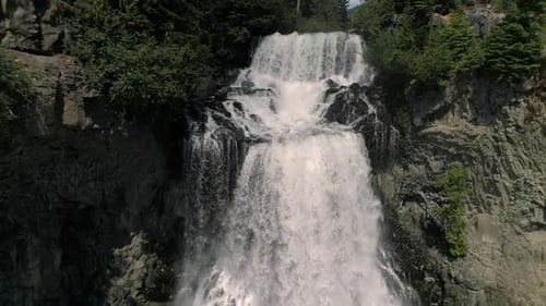 Spectacular Waterfall Aerial Flying Down Canyon Cliff With Water Splashing In Slow Motion